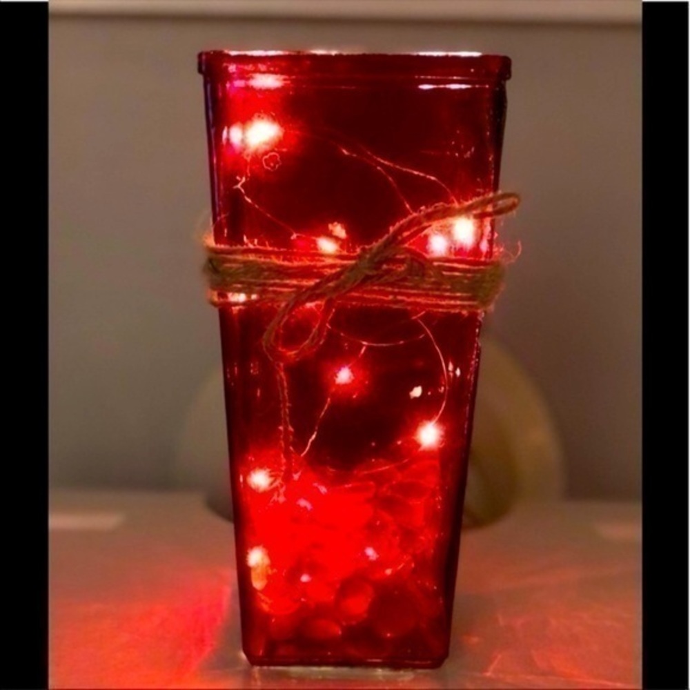 Red vase with lights and twine